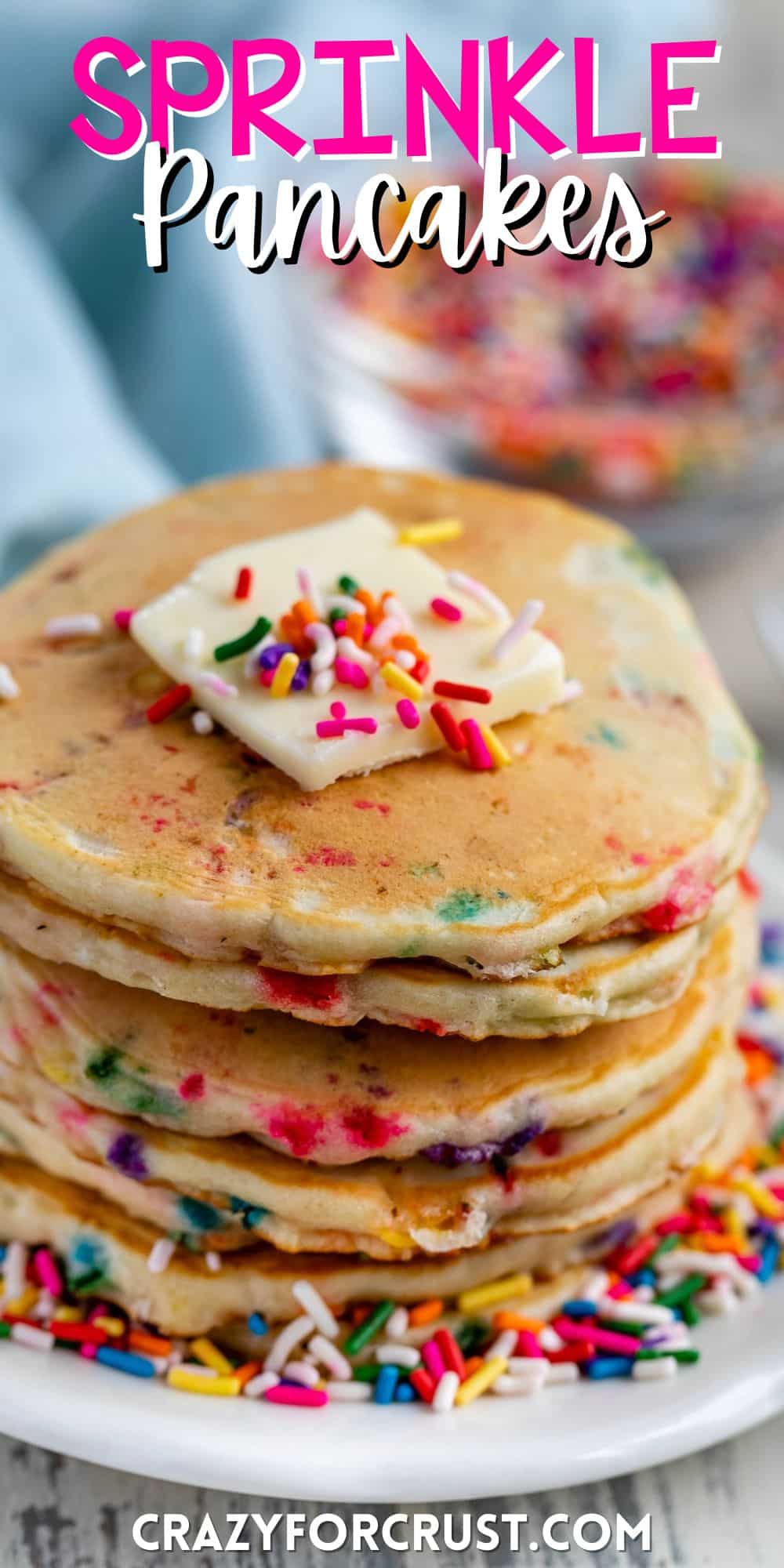 stacked sprinkle pancakes with colorful sprinkles all around and baked in with butter on top with words on the image.
