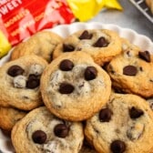 stacked cookies on a white plate with chocolate chips baked in.