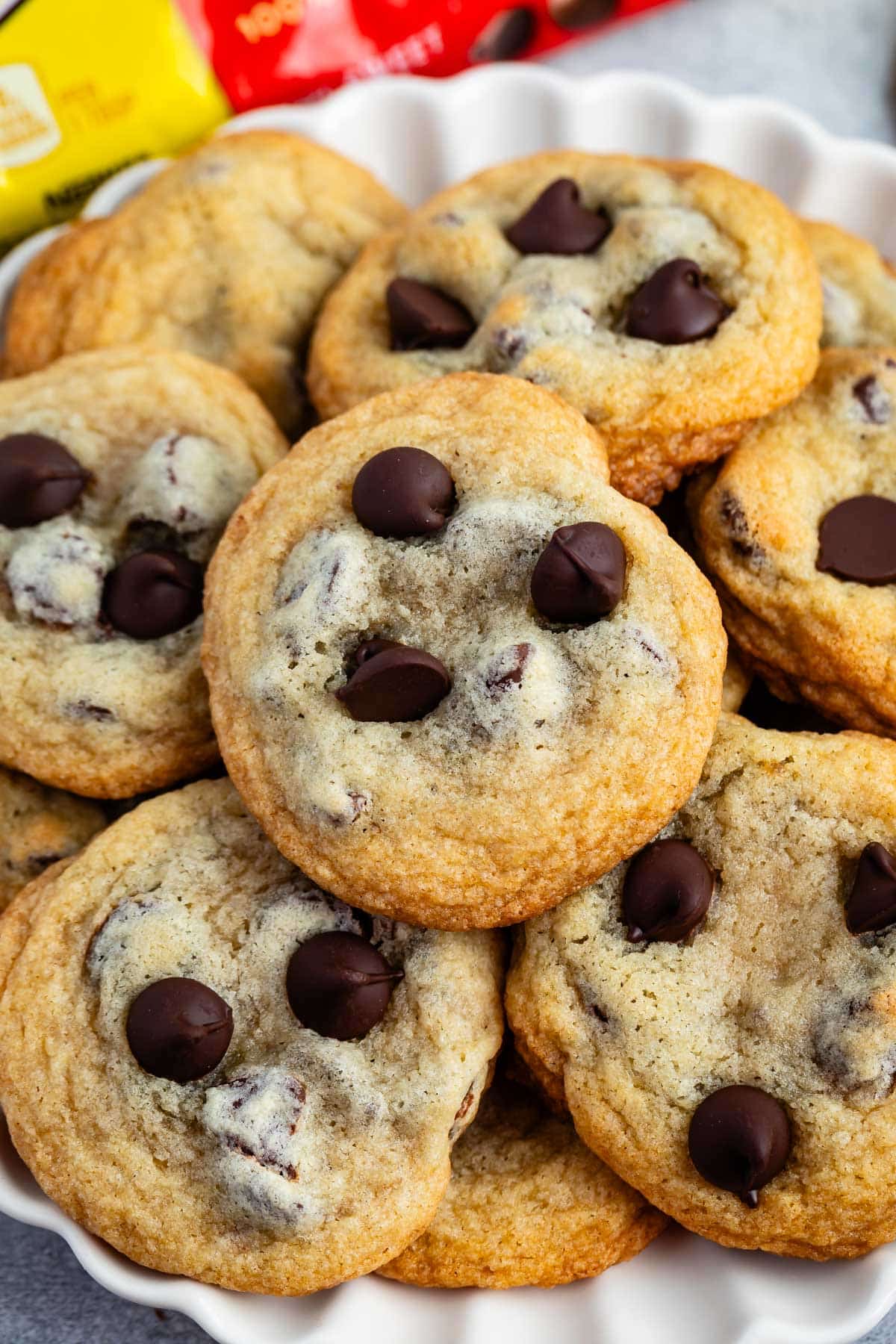 stacked cookies on a white plate with chocolate chips baked in.