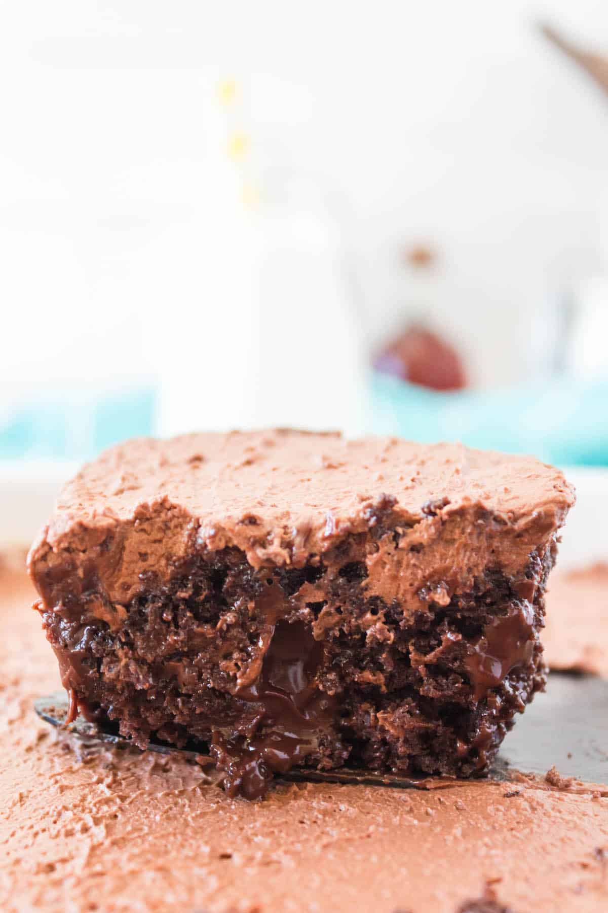 square slice of chocolate cake with a chocolate frosting.