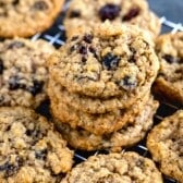 stacked oatmeal cookies with raisins on a drying rack.