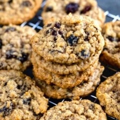 stacked oatmeal cookies with raisins on a drying rack.