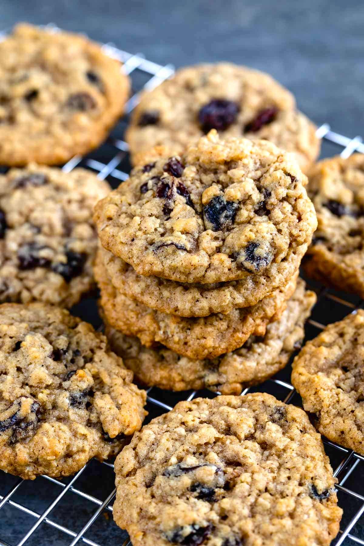 stacked oatmeal cookies with raisins on a drying rack.