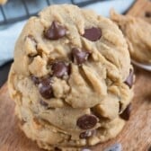 stack of 3 cookies on cutting board.