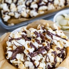 popcorn in a white bowl covered in chocolate drizzle.