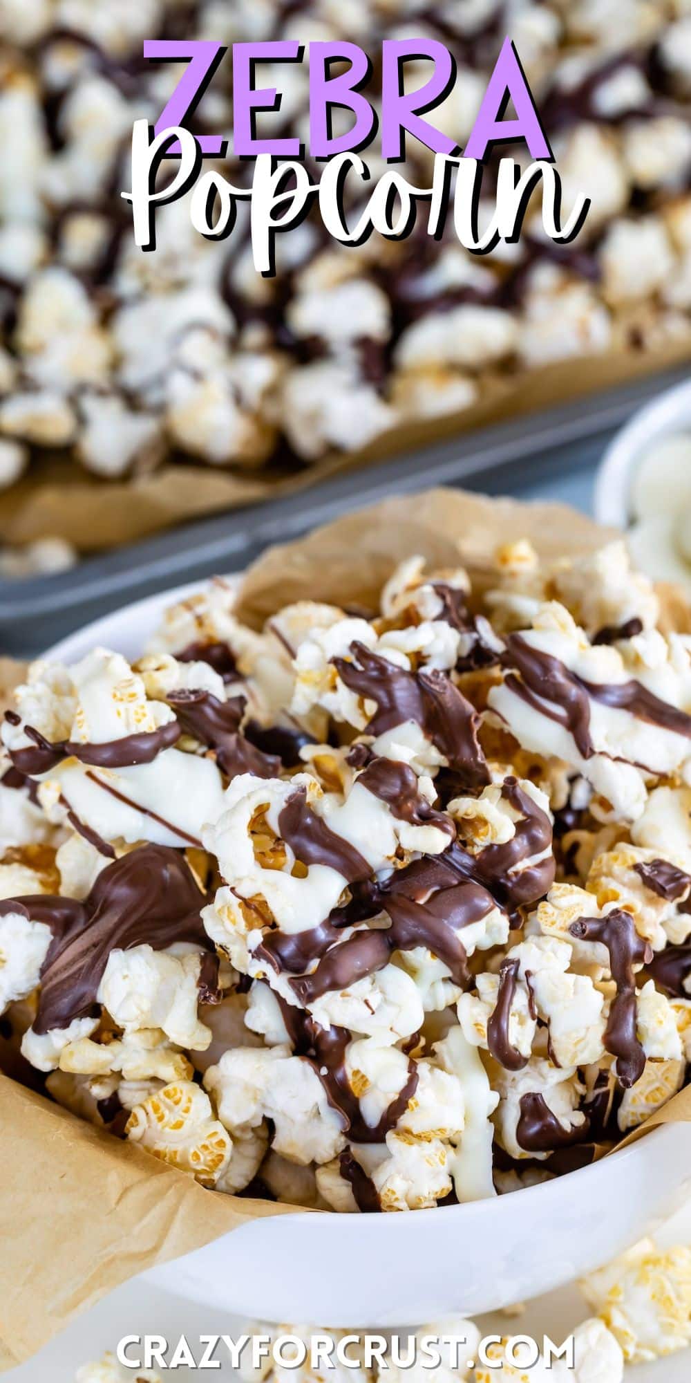 popcorn in a white bowl covered in chocolate drizzle with words on the image.