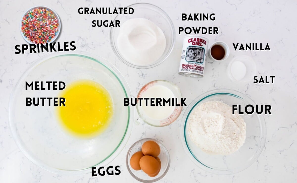ingredients in birthday cake laid out on a white counter.