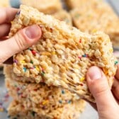 hand holding Rice Krispie treats with sprinkles baked in.