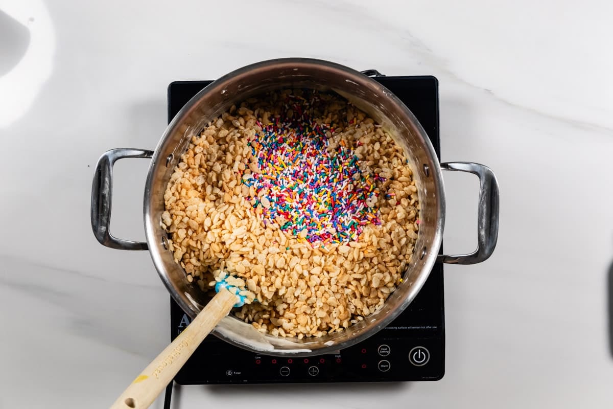 process shot of cake batter Rice Krispie treats being made.