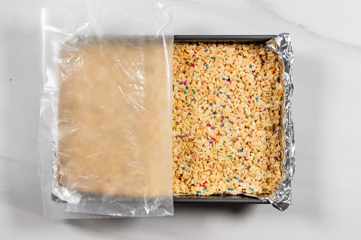 process shot of cake batter Rice Krispie treats being made.