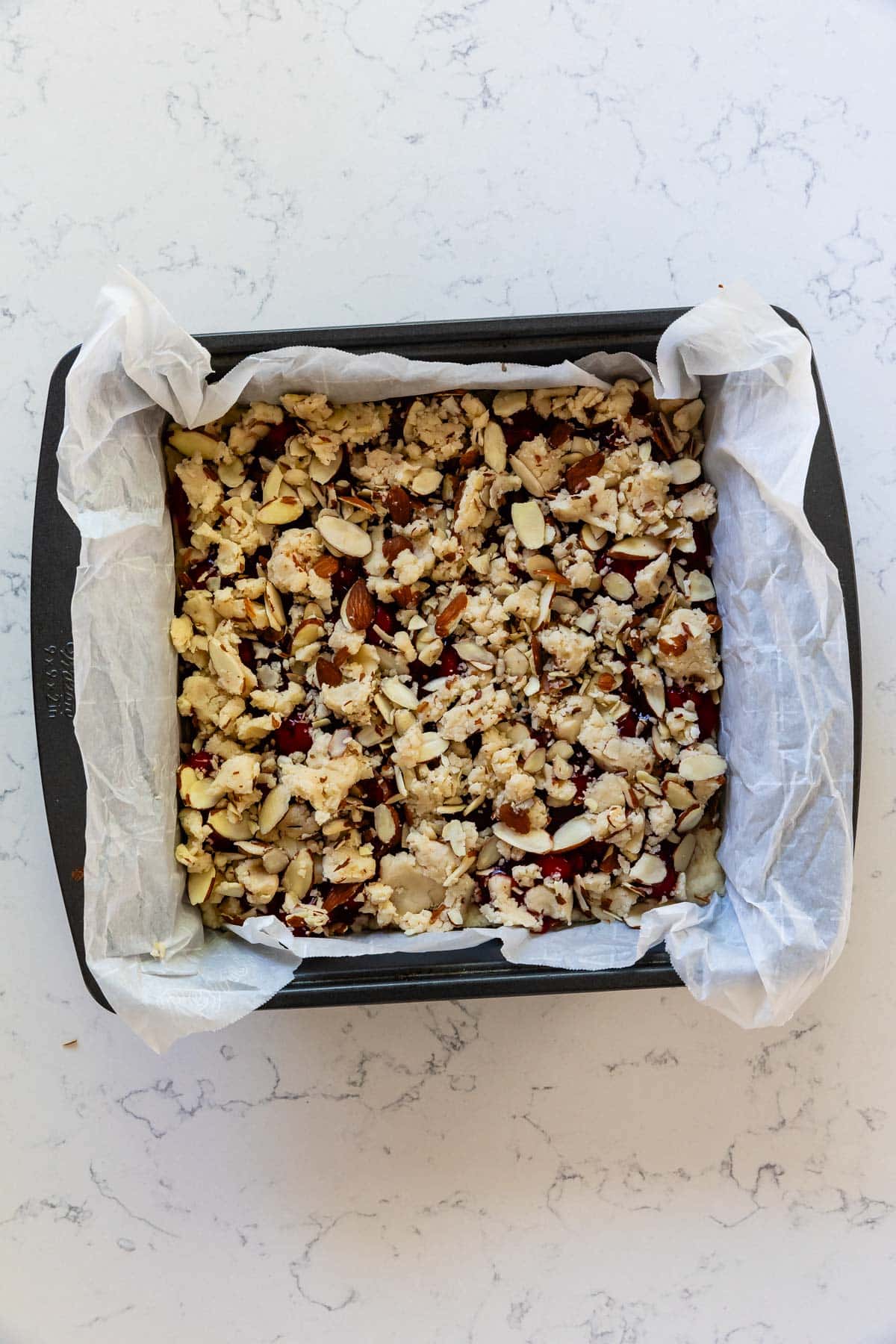 process shot of cherry pie bars being made.