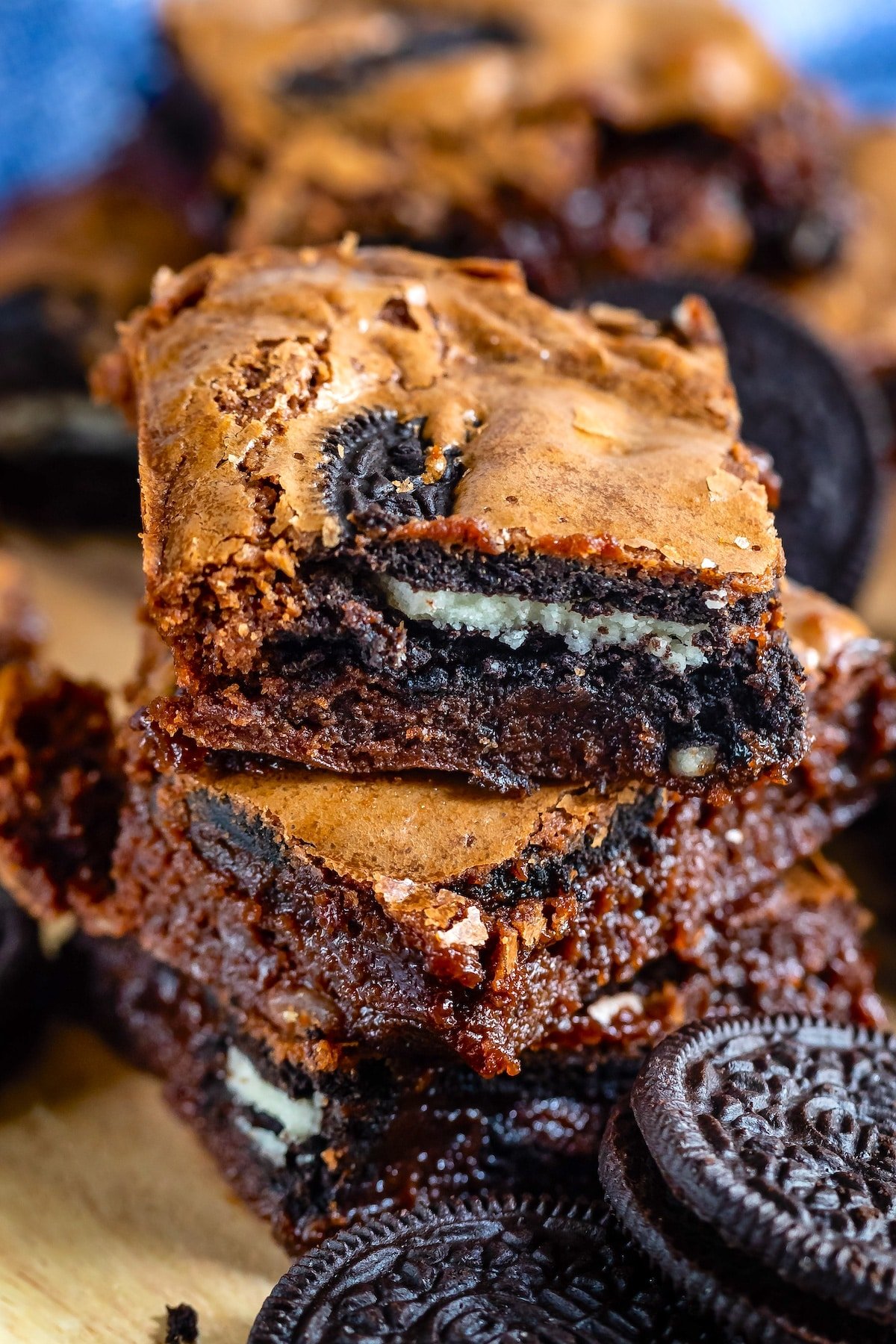 stacked oreo brownies on a cutting board.