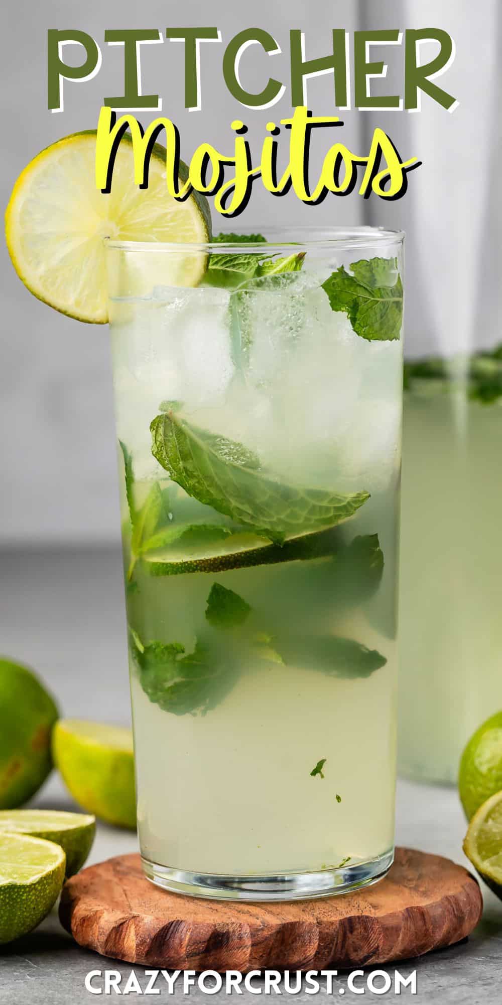 mojito in a tall clear glass with sliced limes in and around the glass with mint with words on the image.
