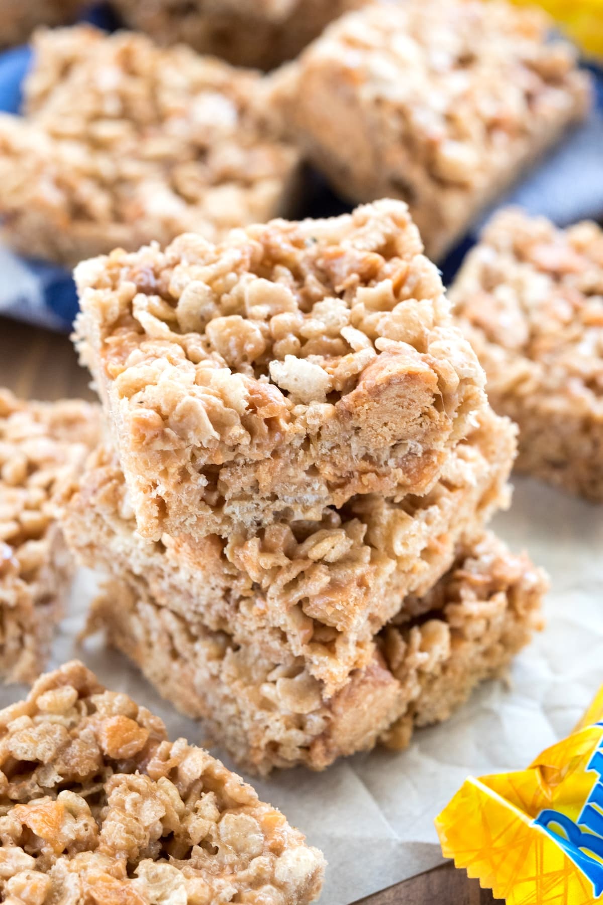 stacked Rice Krispie treats with butterfingers spread around.