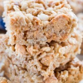 stacked Rice Krispie treats with butterfingers spread around.