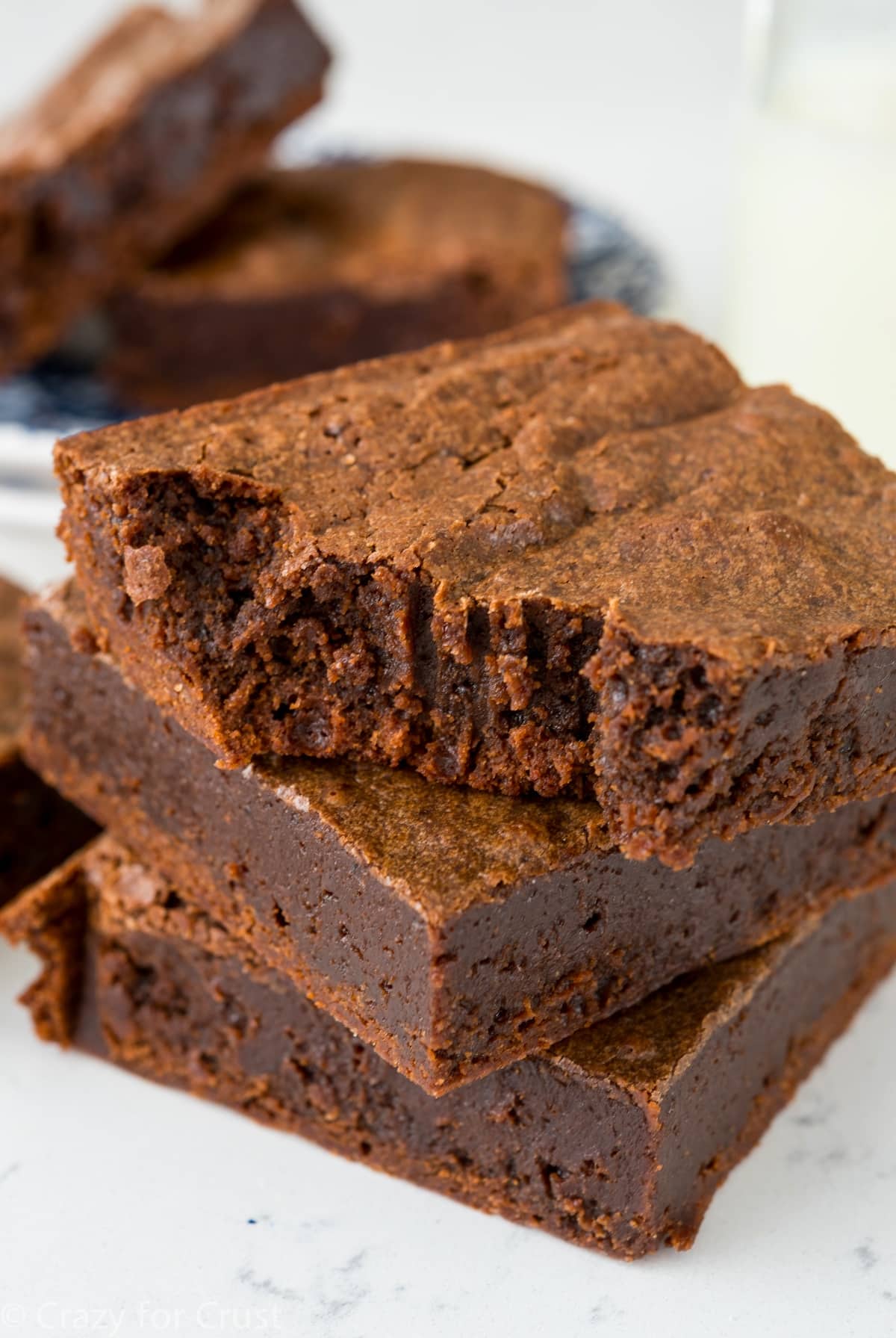 stacked brownies on a white counter.