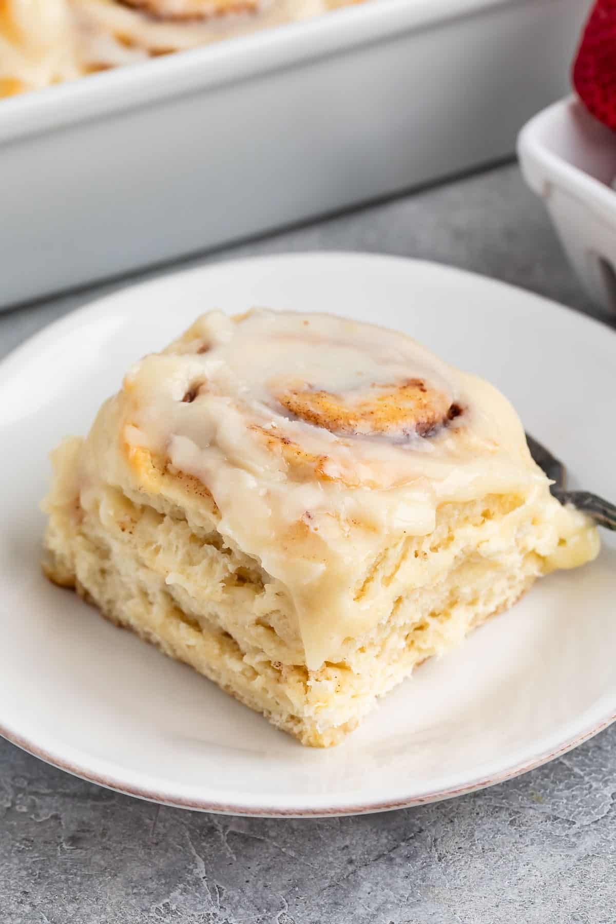 cinnamon roll sitting on a white plate.