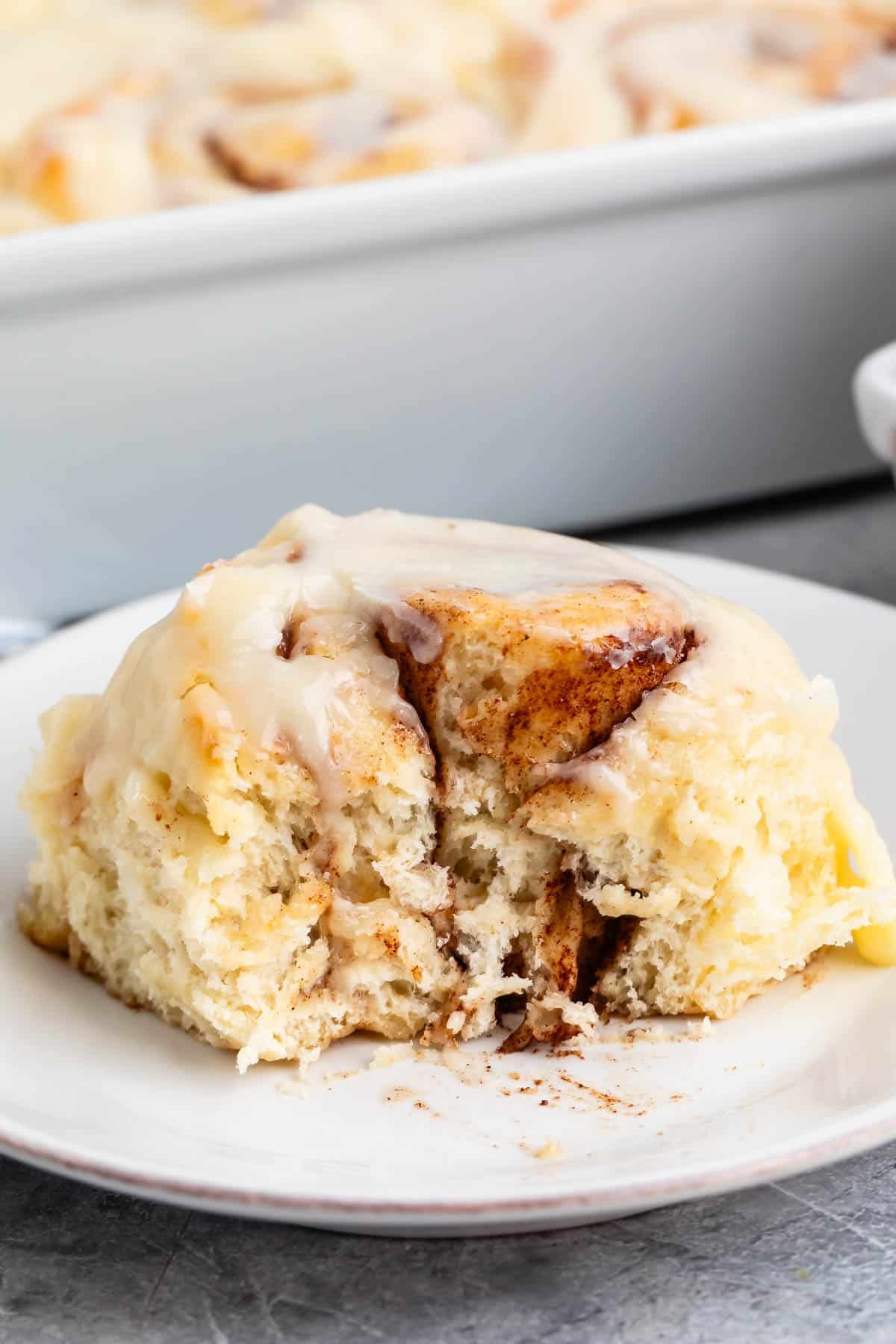 cinnamon roll sitting on a white plate.