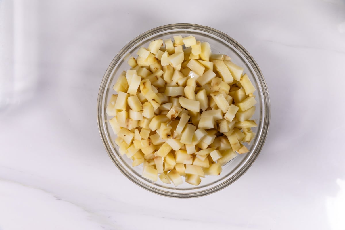 process shot of cheesy potato casserole being made.