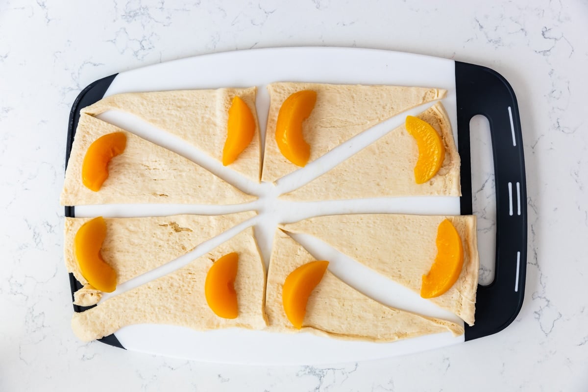 process shot of peach dumplings being made.