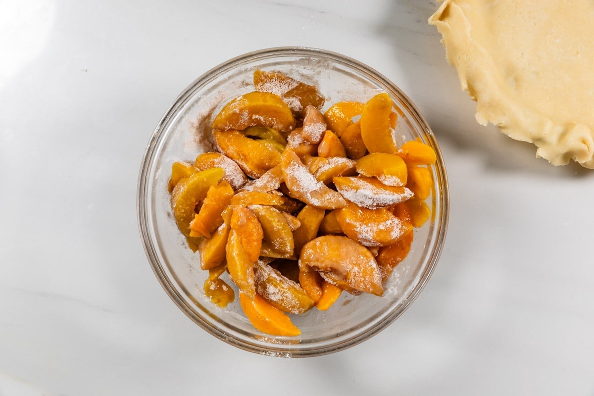 process shot of peach pie being made.