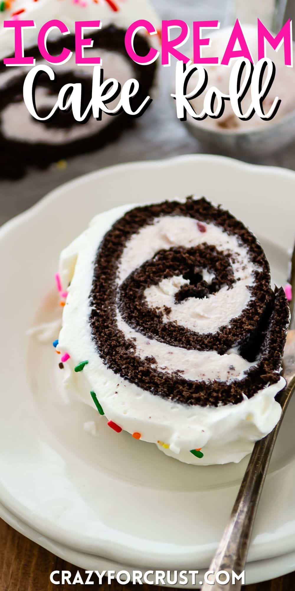chocolate cake roll covered in white frosting and colorful sprinkles with words on the image.