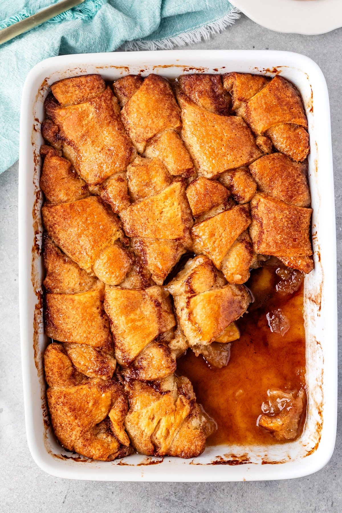 peach dumplings in a white casserole pan.