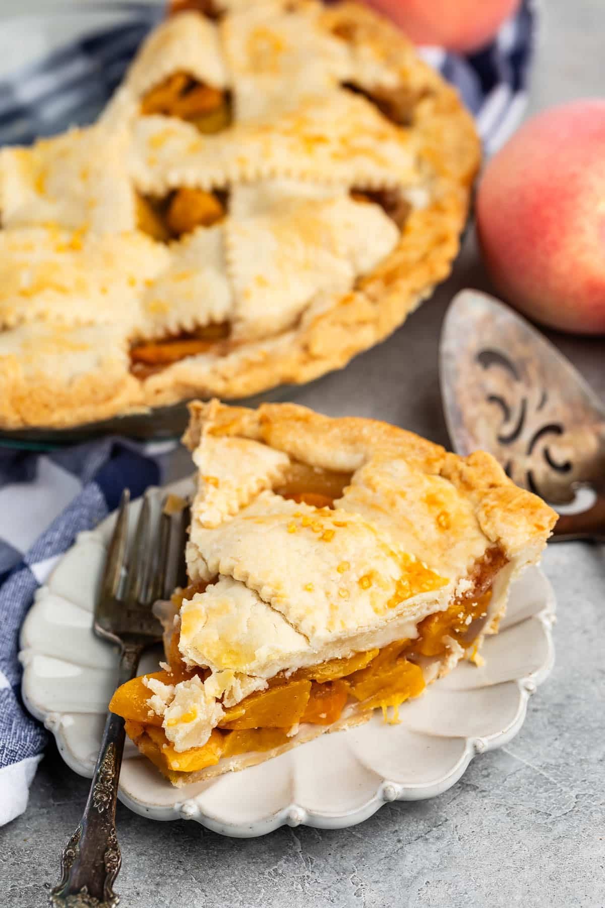lattice topped pie with peached baked into the center in a clear pie.
