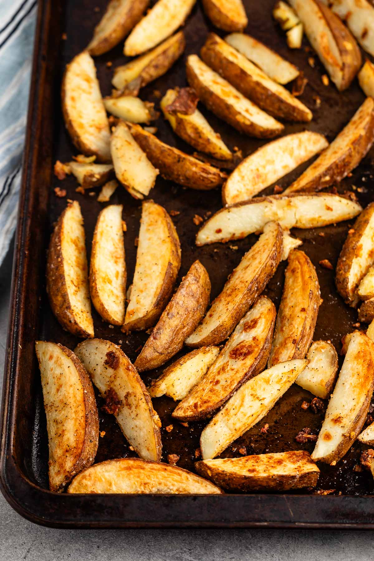 potato wedges on a brown baking sheet.