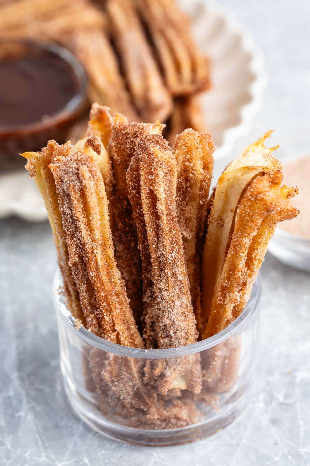 churros propped up together in a clear glass.
