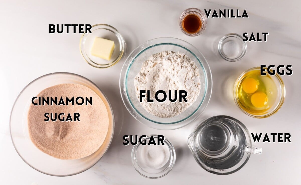 ingredients in baked churros laid out on a white marble counter.