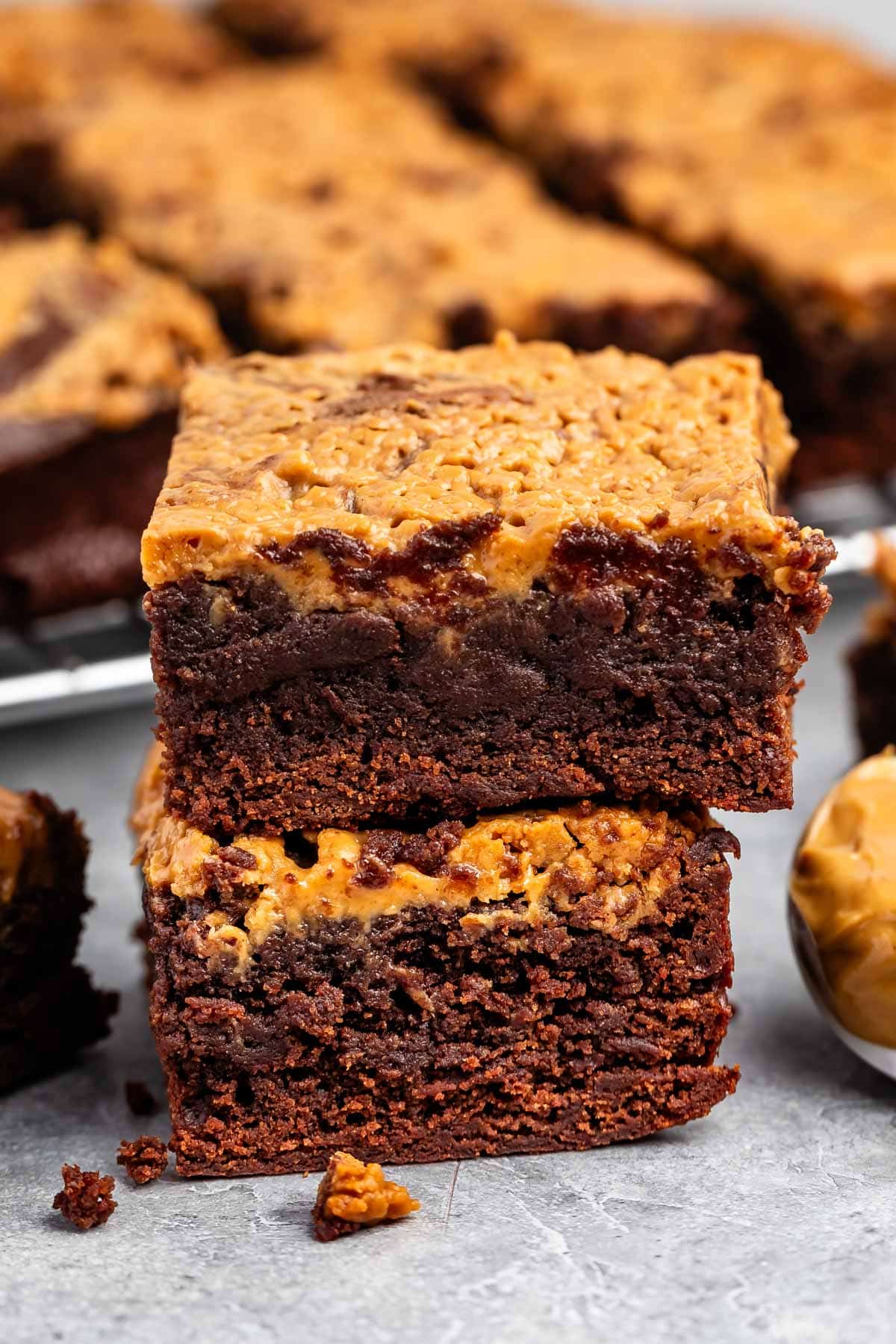 stacked brownies with peanut butter on top.