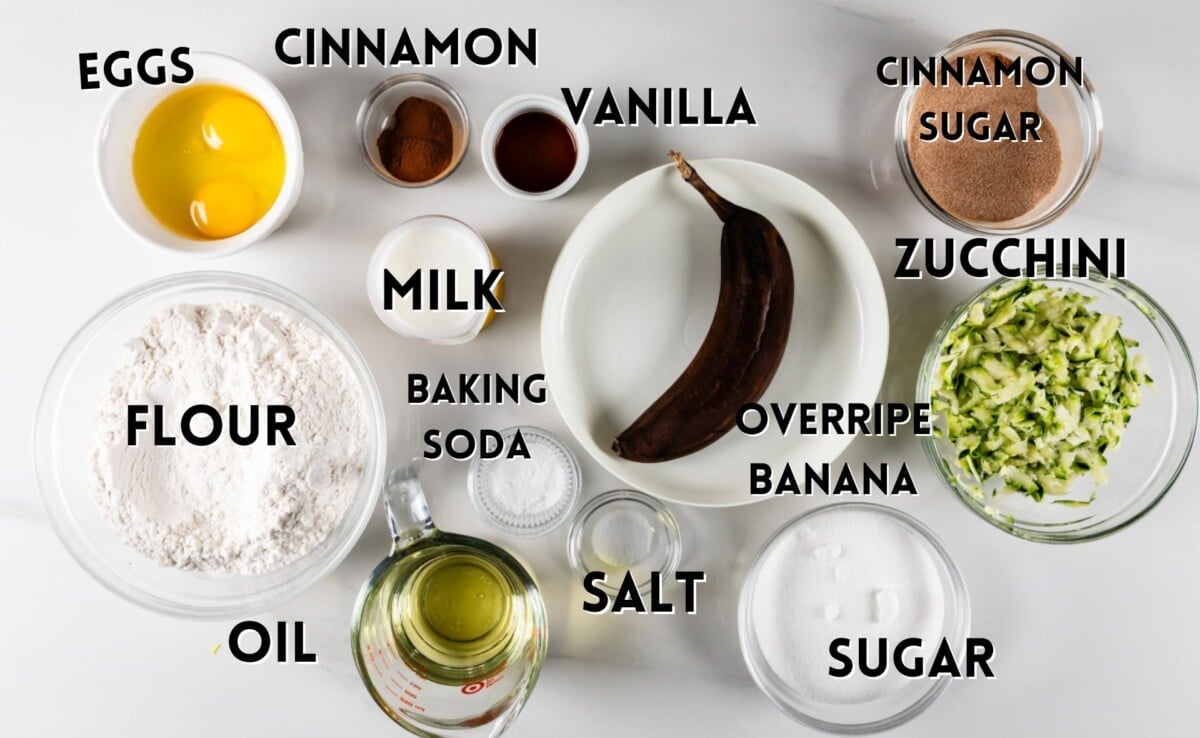 ingredients in zucchini banana bread laid out on a white counter.