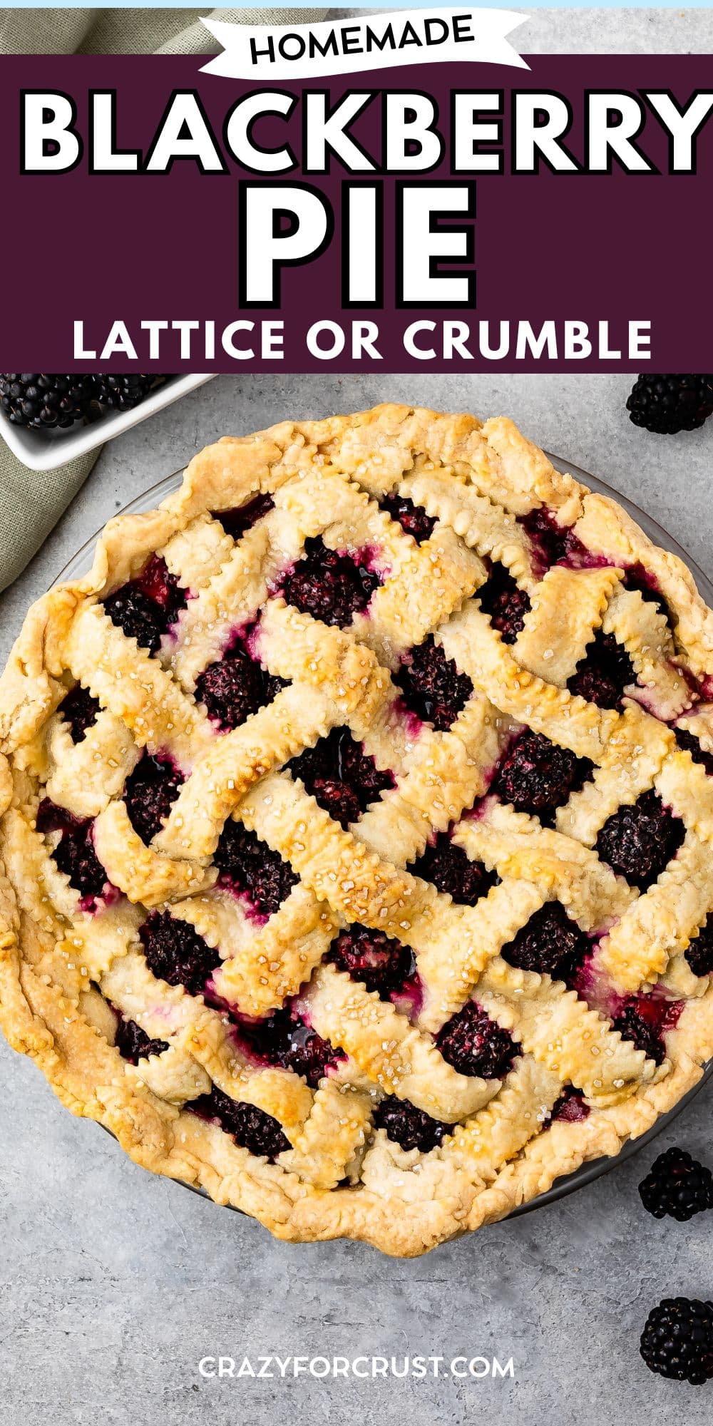 A homemade Blackberry Pie with a golden lattice crust sits on a gray surface, surrounded by fresh blackberries. Text reads: Homemade Blackberry Pie Lattice or Crumble and crazyforcrust.com.