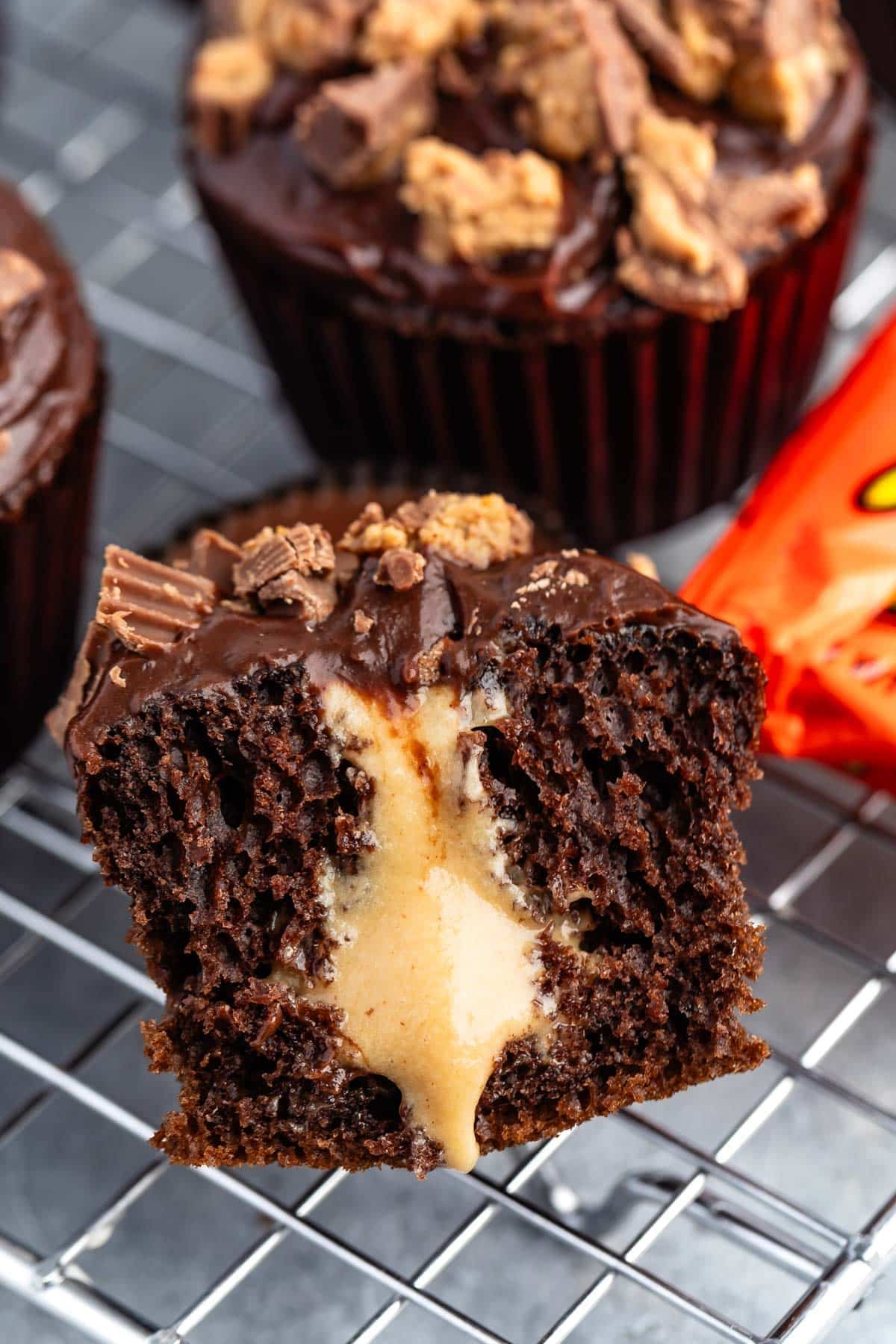 chocolate cupcake cut in half with peanut butter filling pouring out.