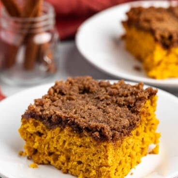 square slice of pumpkin coffee cake on a white plate.