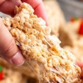 hand pulling apart pumpkin Rice Krispie treat.