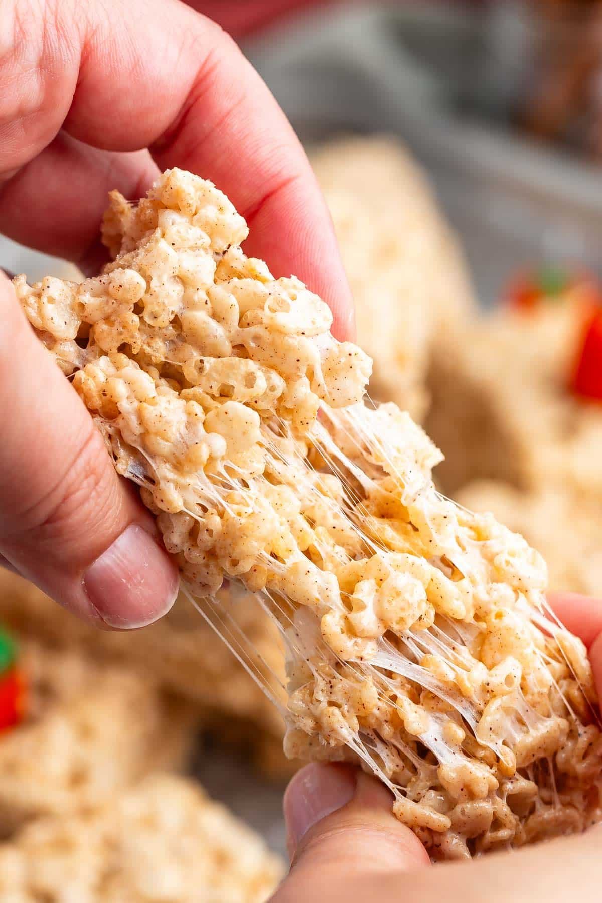 hand pulling apart pumpkin Rice Krispie treat.
