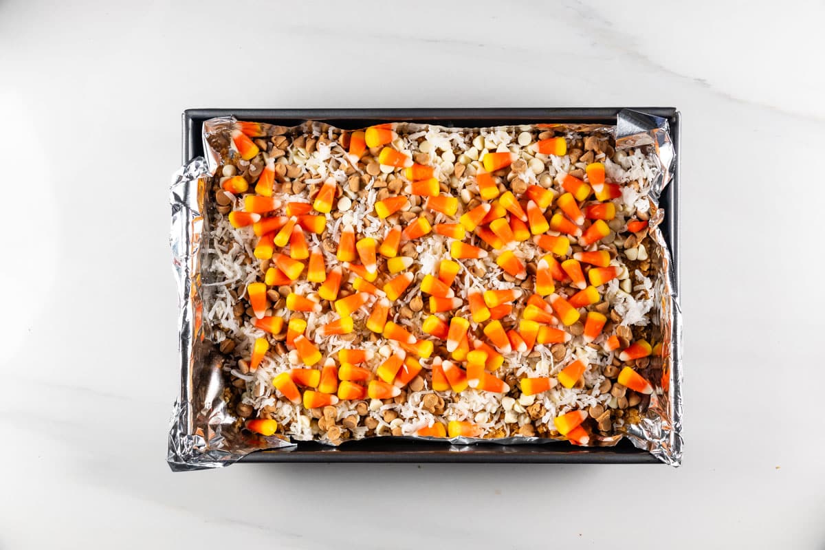 process shot of candy corn magic bars being made.