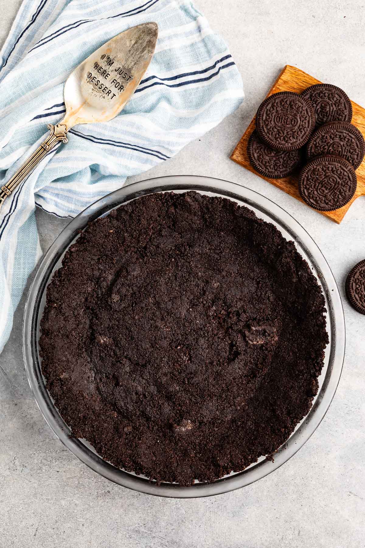 Oreo cookies pressed into a clear pan making an Oreo crust.