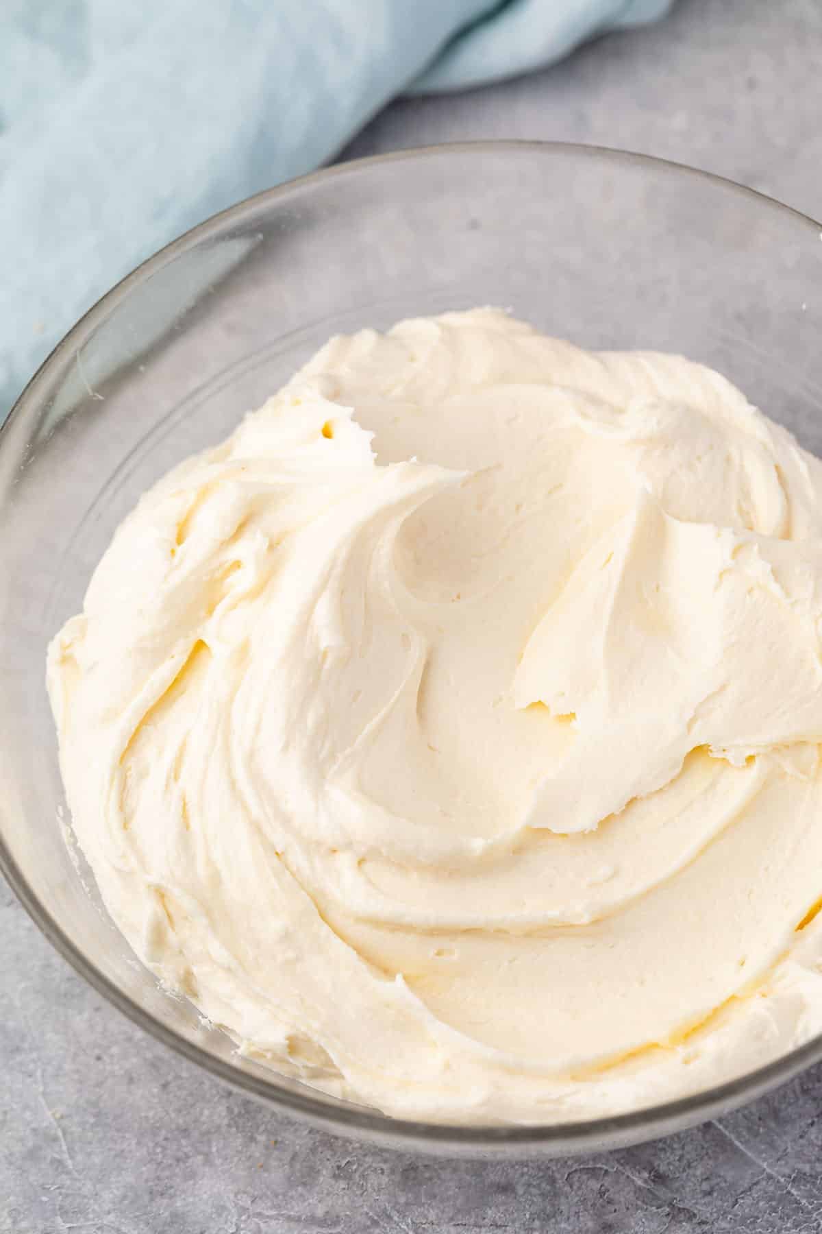 frosting spread across a clear bowl.