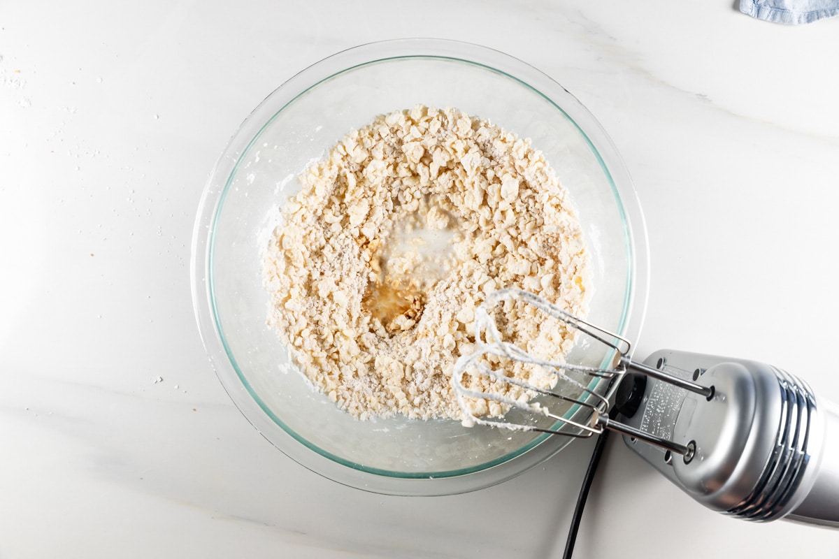 process shot of pumpkin cinnamon rolls being made.