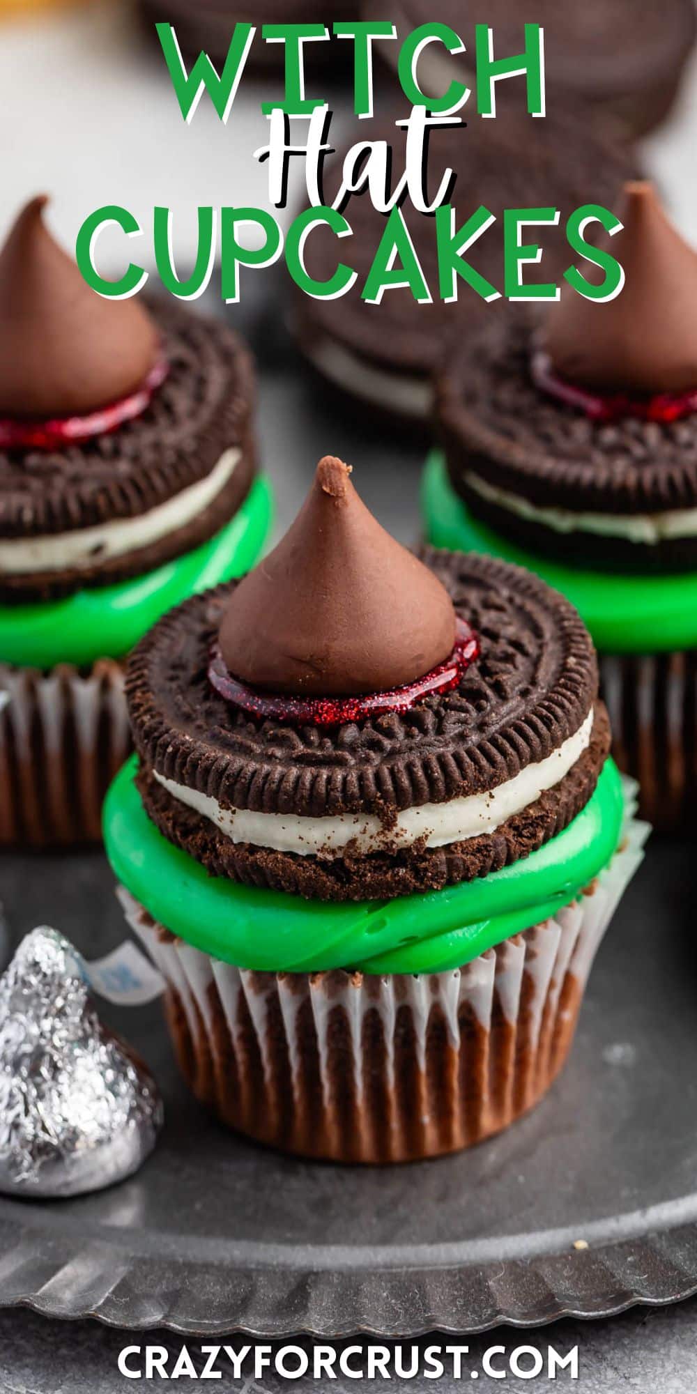 cupcakes with green frosting and a Oreo and kiss on top with words on the image.