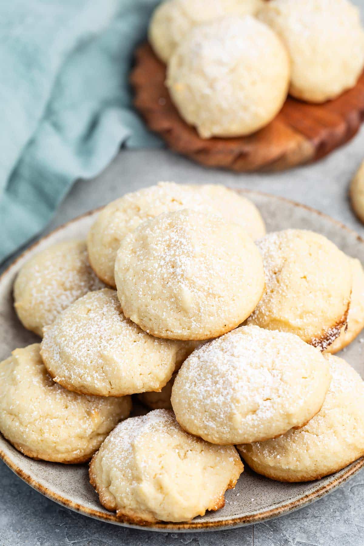 stacked cookies with powdered sugar sprinkled over top.