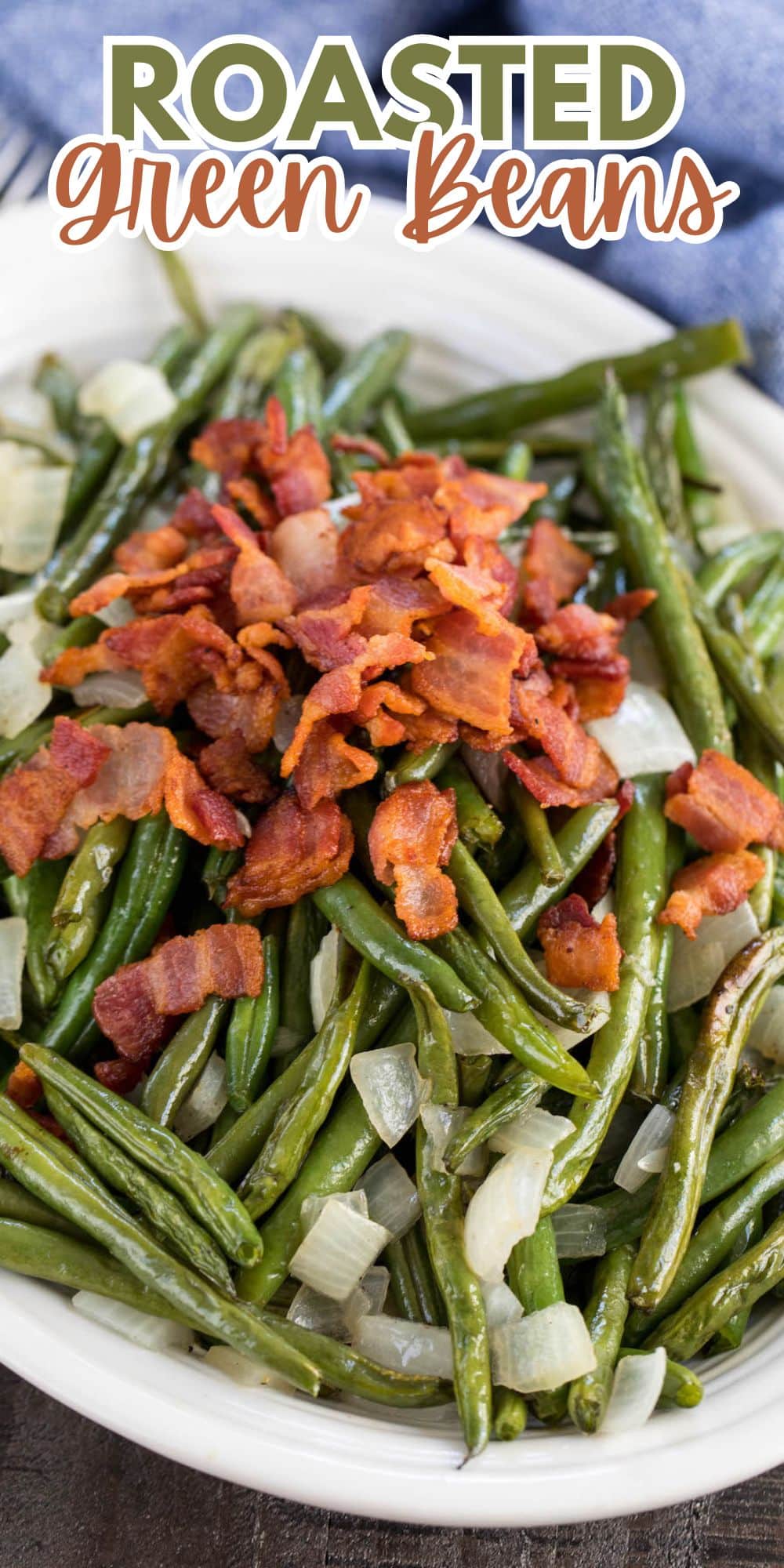 green beans in a white bowl topped with bacon and onions with words on the image.