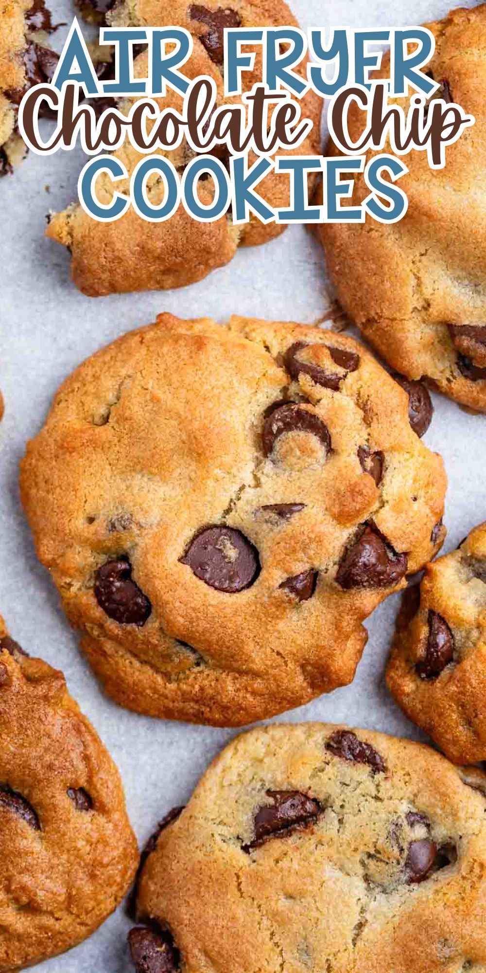 Close-up of several golden-brown chocolate chip cookies on parchment paper. The cookies have dark chocolate chips and a slightly crisp texture. Text overlay at the top reads Air Fryer Chocolate Chip Cookies.