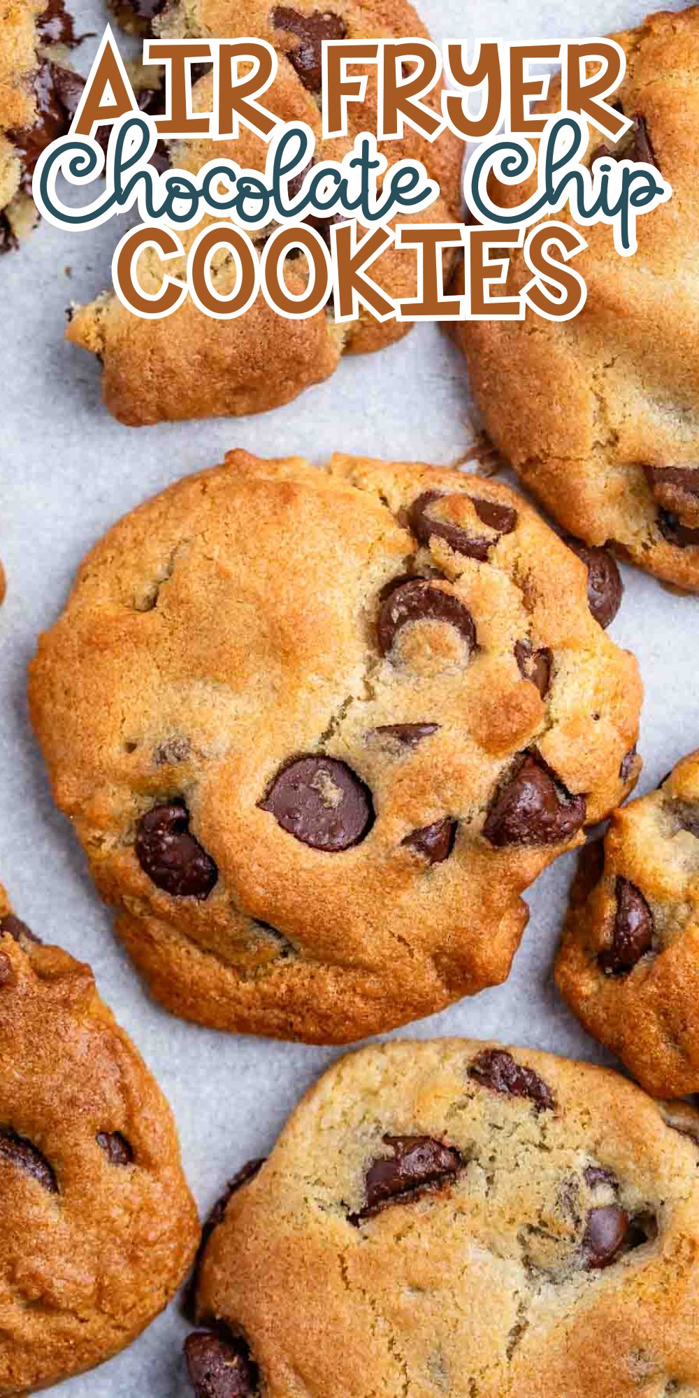 Close-up of golden-brown chocolate chip cookies laid out on parchment paper. The text reads Air Fryer Chocolate Chip Cookies at the top with a playful font.