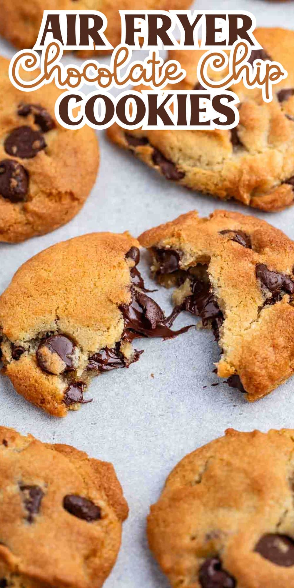 Golden brown chocolate chip cookies with a gooey center, some whole and one split open, arranged on parchment paper. Text on top reads Air Fryer Chocolate Chip Cookies.