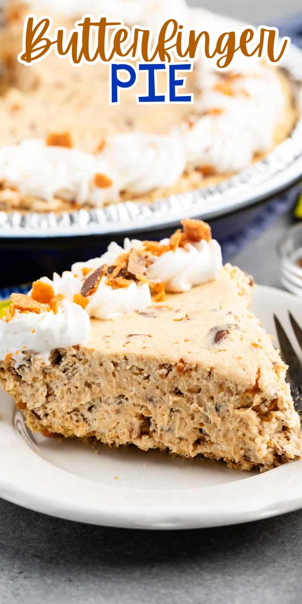 A slice of Butterfinger pie on a white plate with a fork. The pie is creamy with visible chunks and topped with whipped cream and crumbled Butterfinger pieces. The rest of the pie is in the background.