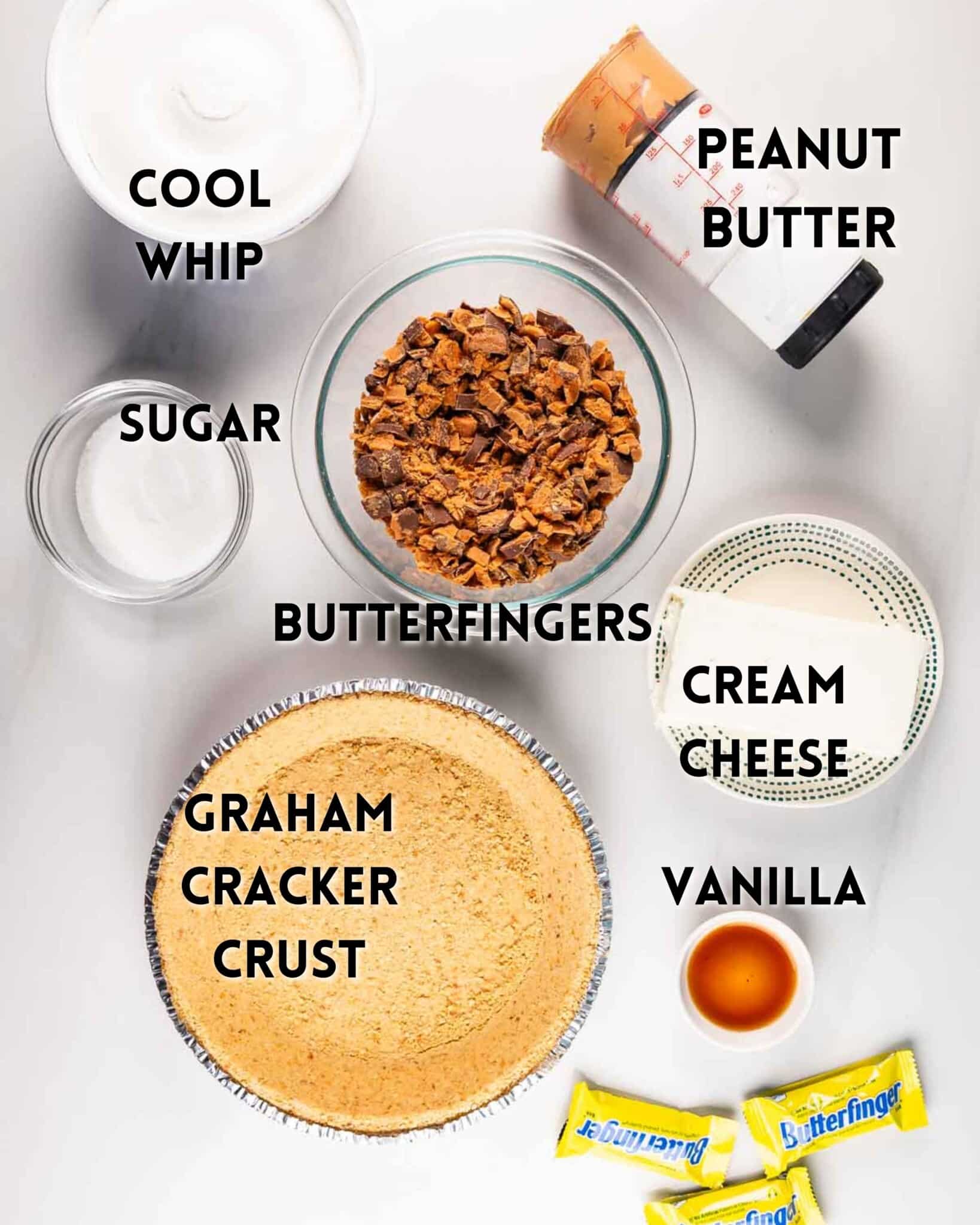 Top view of dessert ingredients on a white surface labeled in black text. Includes Cool Whip, peanut butter, sugar, chopped Butterfingers, cream cheese, vanilla, and a graham cracker crust. Three wrapped Butterfinger bars are at the bottom right.